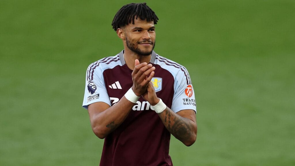 Tyrone Mings celebrates in Aston Villa shirt after signing new contract